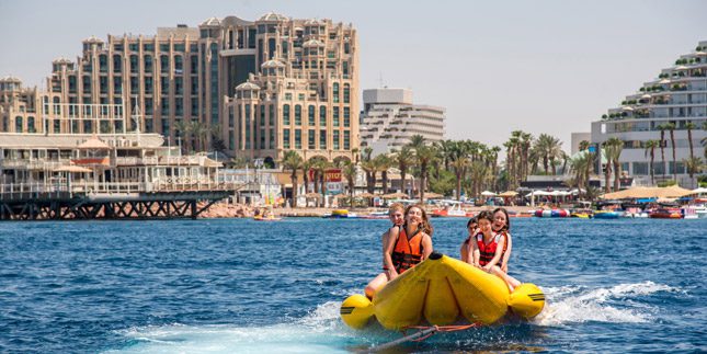 Teens in Israel Riding a Tube on the Water