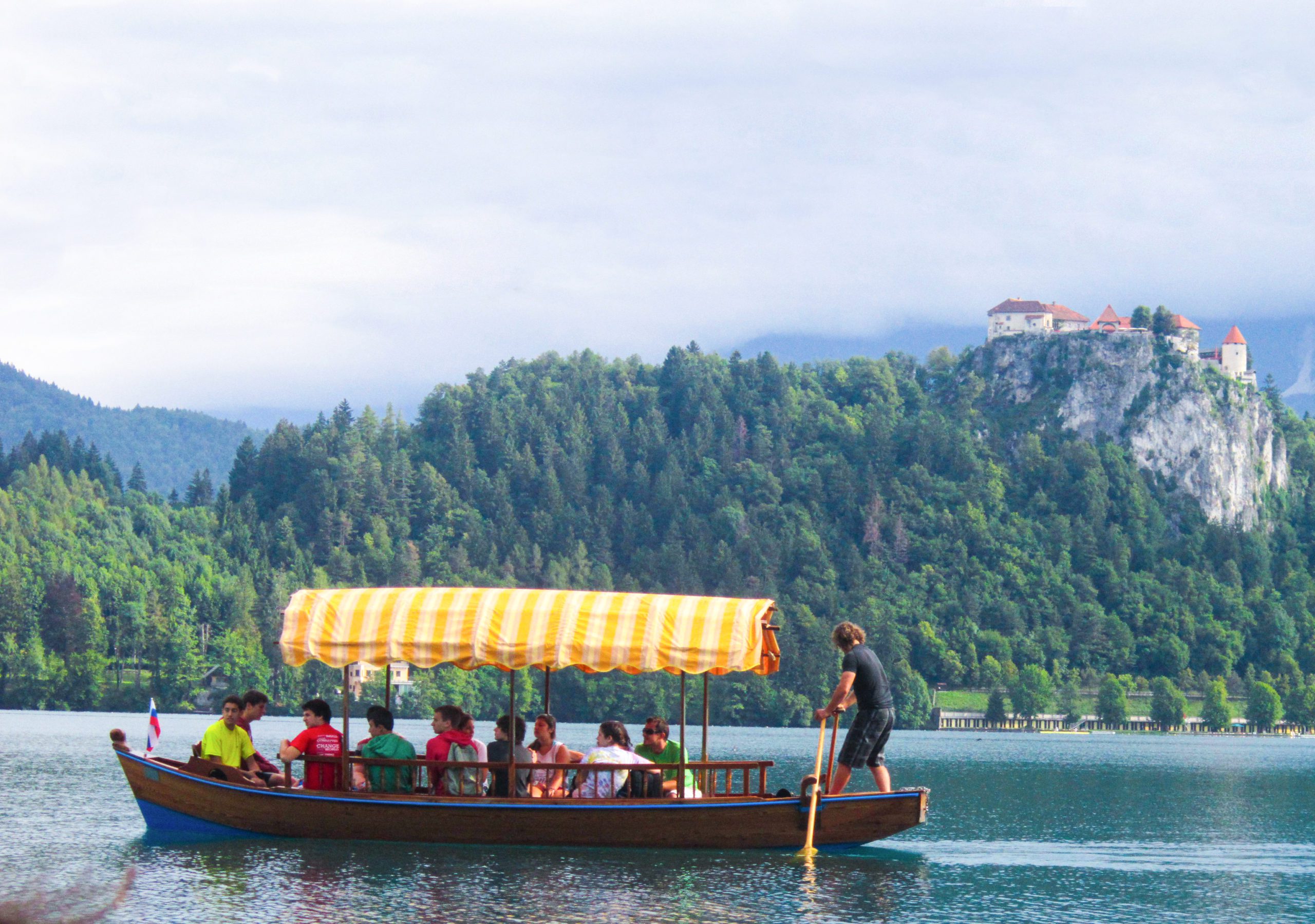 People riding a boat near the mountains