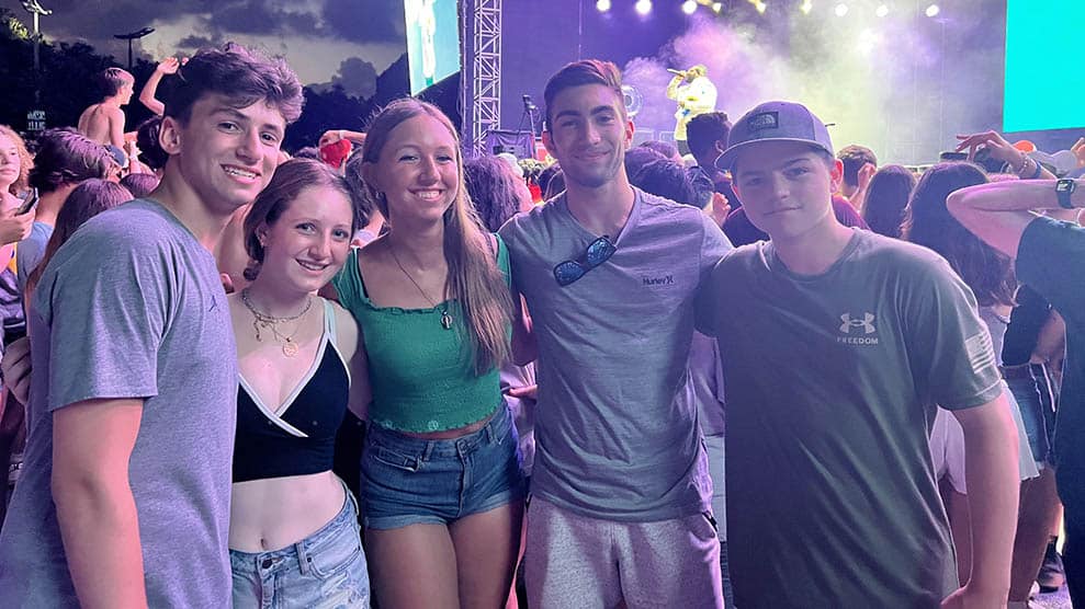 Group shot, smiling teens at concert